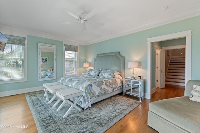 2821 Harborside Way, Southport, NC 28461 - bedroom with multiple windows, crown molding, wood finished floors, and baseboards