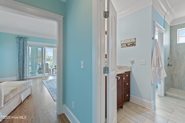 2821 Harborside Way, Southport, NC 28461 - bathroom featuring ornamental molding, walk in shower, vanity, baseboards, and wood finished floors