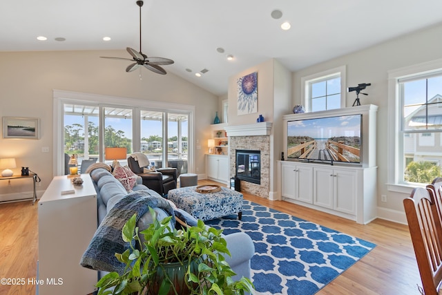2821 Harborside Way, Southport, NC 28461 - living room with healthy amount of natural light, ceiling fan, a glass covered fireplace, lofted ceiling, and recessed lighting