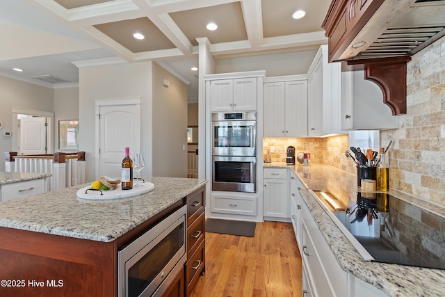 2821 Harborside Way, Southport, NC 28461 - kitchen featuring appliances with stainless steel finishes, ventilation hood, tasteful backsplash, coffered ceiling, and ornamental molding