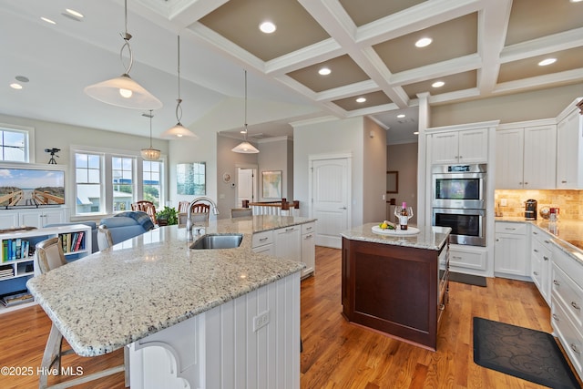 2821 Harborside Way, Southport, NC 28461 - kitchen with a large island, a sink, double oven, backsplash, and a breakfast bar