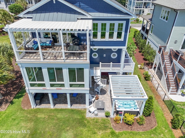 2821 Harborside Way, Southport, NC 28461 - rear view of house featuring a patio area, a pergola, stairway, board and batten siding, and a lawn