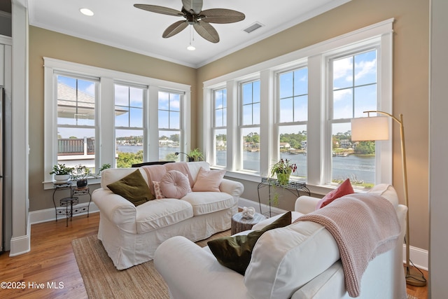 2821 Harborside Way, Southport, NC 28461 - living room with a water view, crown molding, wood finished floors, recessed lighting, and a ceiling fan
