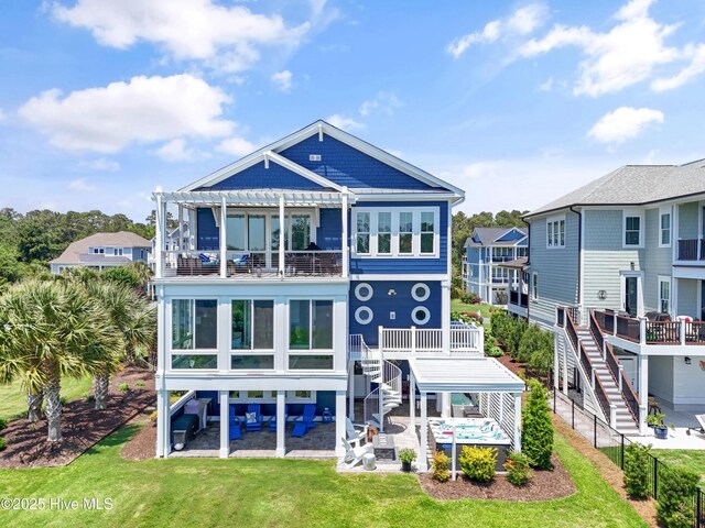 2821 Harborside Way, Southport, NC 28461 - back of property featuring a pergola, a patio, stairs, a balcony, and a lawn