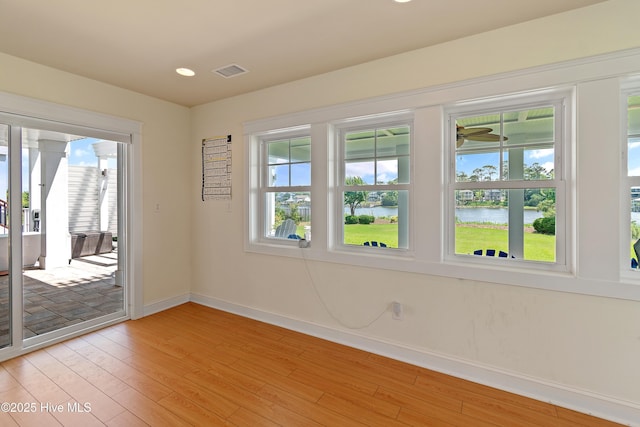 2821 Harborside Way, Southport, NC 28461 - unfurnished room featuring a water view, baseboards, light wood-type flooring, recessed lighting, and a ceiling fan
