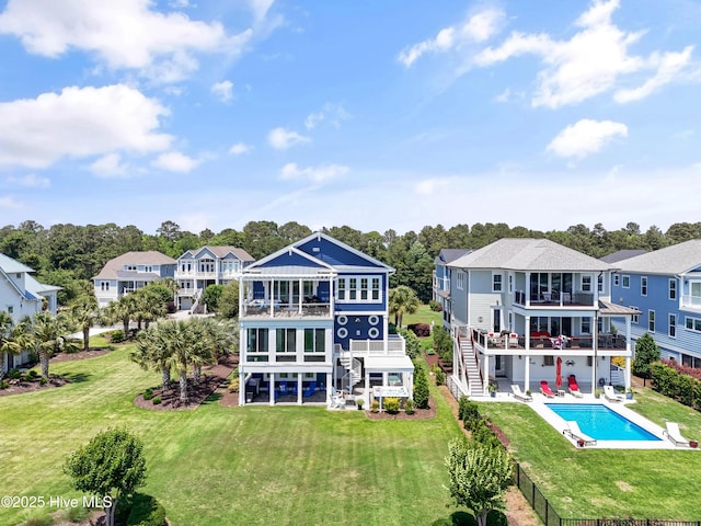 2821 Harborside Way, Southport, NC 28461 - rear view of house featuring a balcony, stairway, a patio area, and an outdoor pool