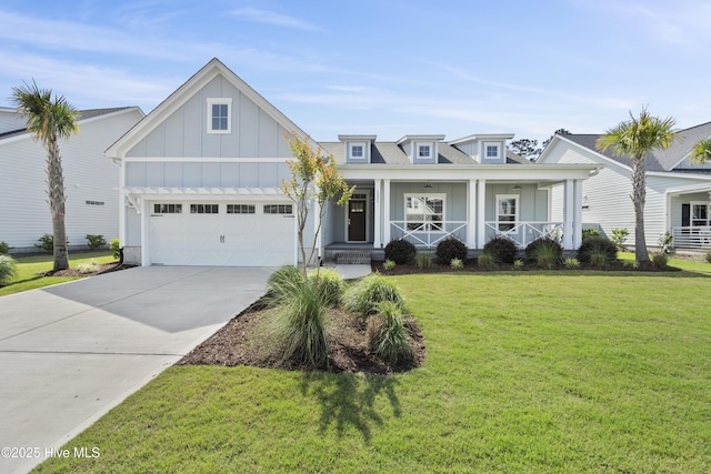 1331 Landover Dr SW, Ocean Isle Beach, NC 28469 - view of front of house with board and batten siding, an attached garage, concrete driveway, a front yard, and covered porch