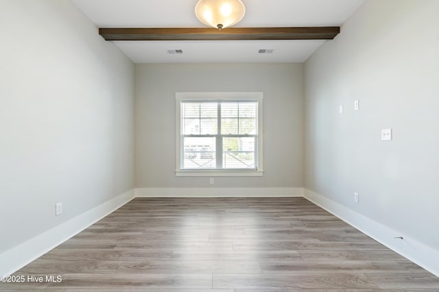 1331 Landover Dr SW, Ocean Isle Beach, NC 28469 - empty room featuring beam ceiling, light wood-style floors, and baseboards