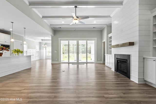 1331 Landover Dr SW, Ocean Isle Beach, NC 28469 - unfurnished living room with a ceiling fan, a large fireplace, crown molding, recessed lighting, and beam ceiling