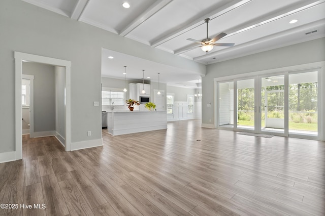 1331 Landover Dr SW, Ocean Isle Beach, NC 28469 - unfurnished living room featuring ceiling fan, baseboards, beam ceiling, light wood-type flooring, and recessed lighting