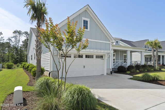 1331 Landover Dr SW, Ocean Isle Beach, NC 28469 - view of front of house with board and batten siding, driveway, covered porch, and a front lawn