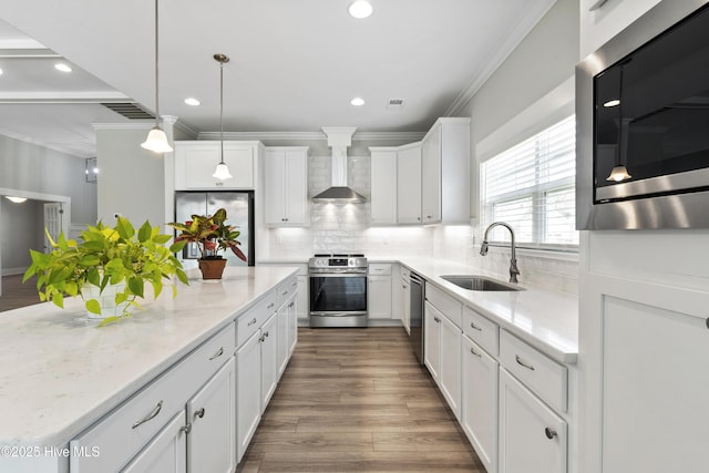 1331 Landover Dr SW, Ocean Isle Beach, NC 28469 - kitchen featuring appliances with stainless steel finishes, wall chimney range hood, a sink, a kitchen island, and ornamental molding