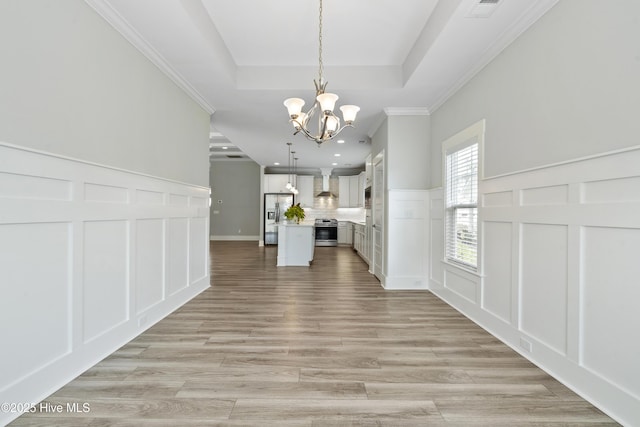 1331 Landover Dr SW, Ocean Isle Beach, NC 28469 - unfurnished dining area featuring a decorative wall, a chandelier, a wainscoted wall, light wood-style flooring, and recessed lighting