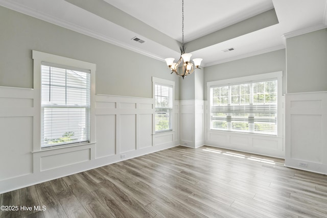 1331 Landover Dr SW, Ocean Isle Beach, NC 28469 - empty room with a decorative wall, a chandelier, wood finished floors, a wainscoted wall, and ornamental molding