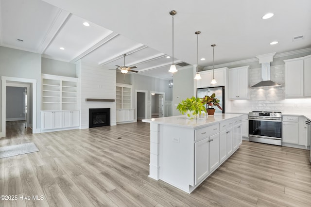 1331 Landover Dr SW, Ocean Isle Beach, NC 28469 - kitchen featuring appliances with stainless steel finishes, wall chimney exhaust hood, a ceiling fan, light countertops, and beamed ceiling