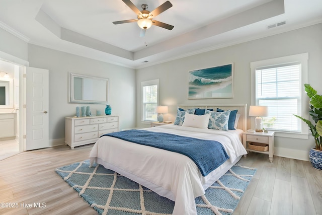 1331 Landover Dr SW, Ocean Isle Beach, NC 28469 - bedroom with a tray ceiling, light wood finished floors, baseboards, ornamental molding, and a ceiling fan