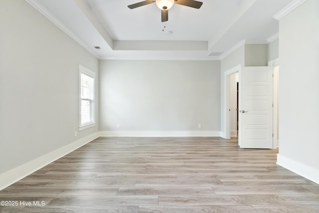 1331 Landover Dr SW, Ocean Isle Beach, NC 28469 - spare room featuring a raised ceiling, ceiling fan, light wood finished floors, and baseboards