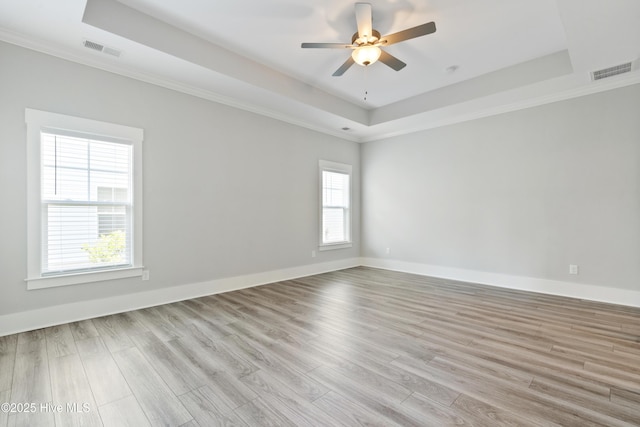 1331 Landover Dr SW, Ocean Isle Beach, NC 28469 - unfurnished room featuring a raised ceiling, wood finished floors, ceiling fan, ornamental molding, and baseboards