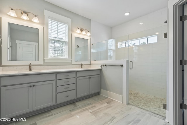 1331 Landover Dr SW, Ocean Isle Beach, NC 28469 - bathroom featuring healthy amount of natural light, a shower stall, double vanity, and recessed lighting