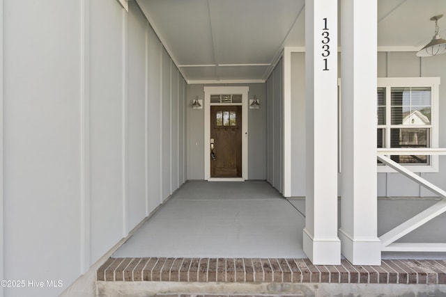 1331 Landover Dr SW, Ocean Isle Beach, NC 28469 - view of exterior entry featuring board and batten siding and a porch