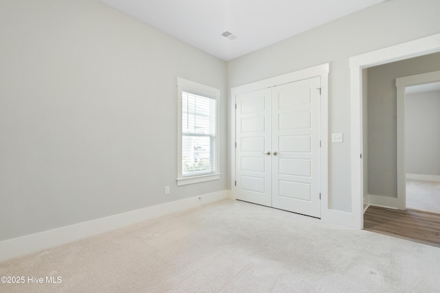 1331 Landover Dr SW, Ocean Isle Beach, NC 28469 - unfurnished bedroom featuring carpet, a closet, and baseboards