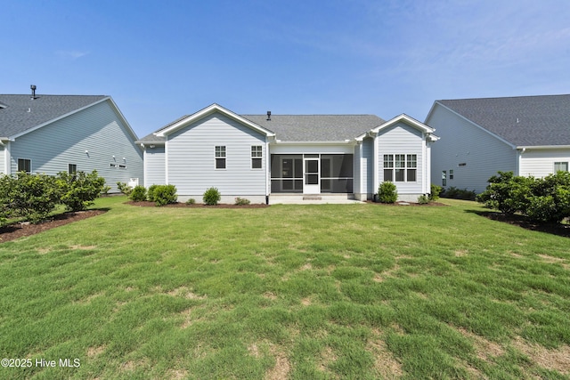 1331 Landover Dr SW, Ocean Isle Beach, NC 28469 - rear view of house with a sunroom and a lawn