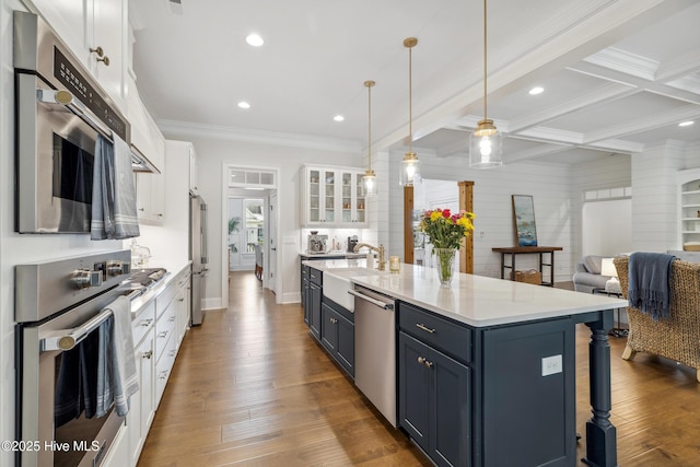 580 Jackline Dr, Hampstead, NC 28443 - kitchen with a breakfast bar, ornamental molding, white cabinetry, light countertops, and stainless steel appliances