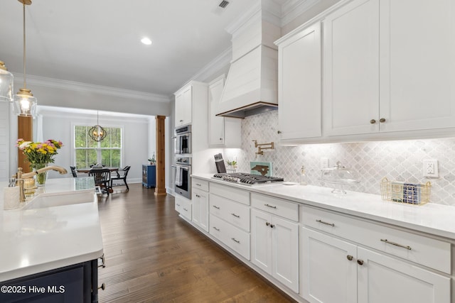 580 Jackline Dr, Hampstead, NC 28443 - kitchen with custom exhaust hood, white cabinetry, a sink, and appliances with stainless steel finishes