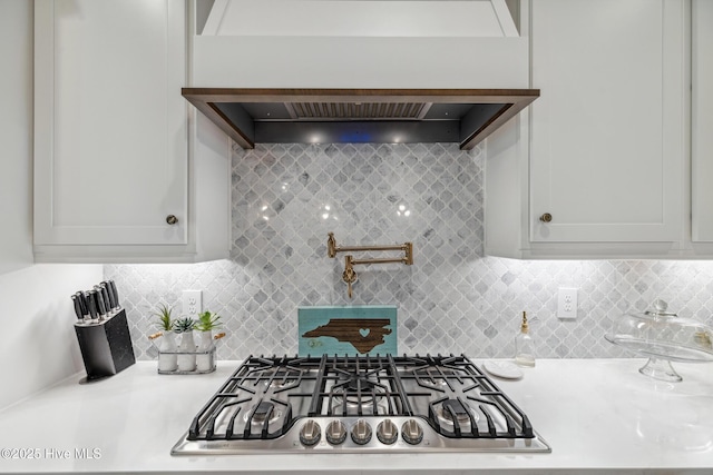 580 Jackline Dr, Hampstead, NC 28443 - kitchen with white cabinets, tasteful backsplash, stainless steel gas stovetop, and light countertops