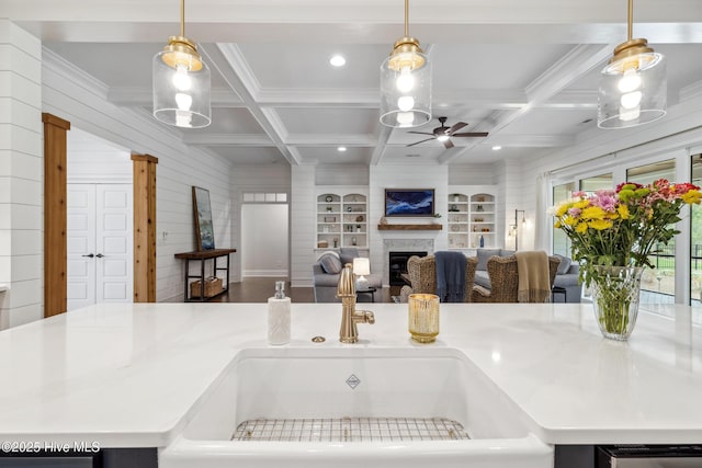 580 Jackline Dr, Hampstead, NC 28443 - kitchen featuring a sink, a ceiling fan, coffered ceiling, and a fireplace