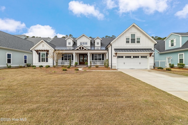 580 Jackline Dr, Hampstead, NC 28443 - modern inspired farmhouse with board and batten siding, a porch, metal roof, and a standing seam roof