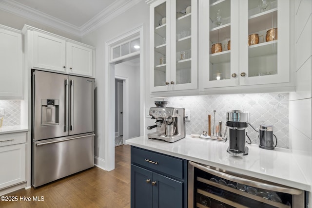 580 Jackline Dr, Hampstead, NC 28443 - bar with dark wood finished floors, ornamental molding, high end refrigerator, wine cooler, and decorative backsplash