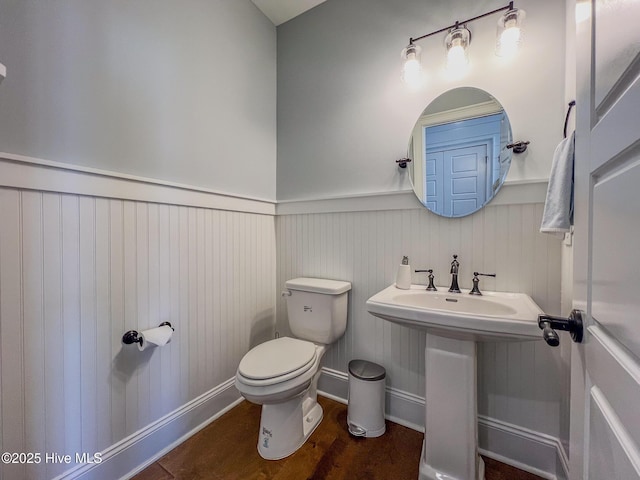 580 Jackline Dr, Hampstead, NC 28443 - half bathroom with toilet, a sink, a wainscoted wall, and wood finished floors