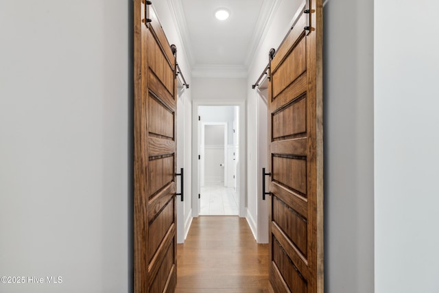 580 Jackline Dr, Hampstead, NC 28443 - hall featuring dark wood-type flooring, a barn door, and crown molding
