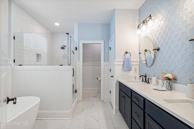580 Jackline Dr, Hampstead, NC 28443 - bathroom featuring a freestanding tub, a wainscoted wall, a shower stall, marble finish floor, and a sink