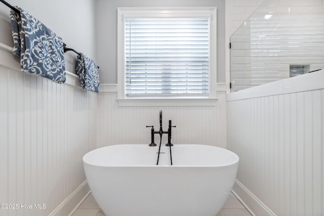 580 Jackline Dr, Hampstead, NC 28443 - full bathroom with a wainscoted wall, a freestanding tub, and tile patterned flooring