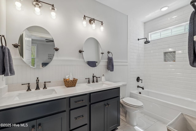 580 Jackline Dr, Hampstead, NC 28443 - bathroom featuring toilet, double vanity, a sink, and wainscoting