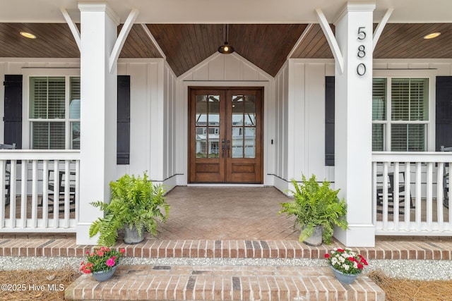 580 Jackline Dr, Hampstead, NC 28443 - property entrance featuring a porch, french doors, and board and batten siding