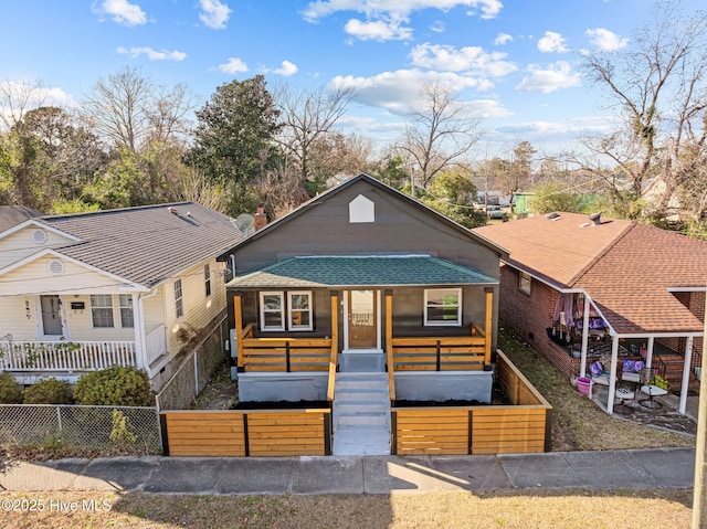 608 S 14th St, Wilmington, NC 28401 - view of front of house with a shingled roof, a fenced front yard, and covered porch