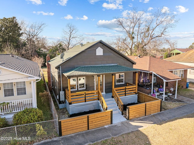 608 S 14th St, Wilmington, NC 28401 - bungalow with covered porch, an outdoor living space, a fenced front yard, and roof with shingles