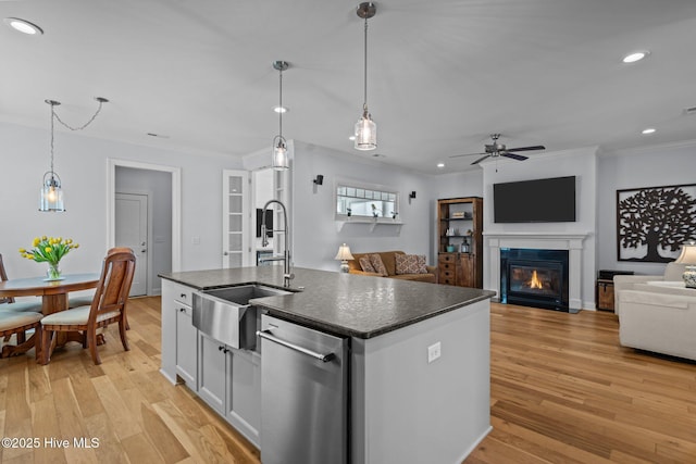 kitchen with recessed lighting, stainless steel dishwasher, ornamental molding, and a sink