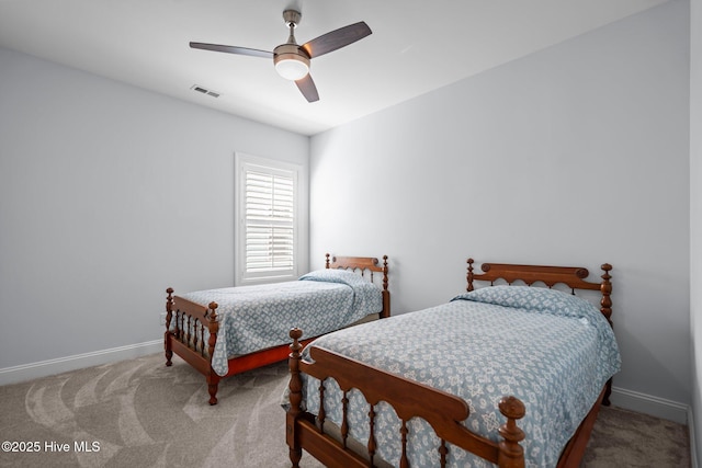 bedroom with baseboards, visible vents, carpet flooring, and ceiling fan