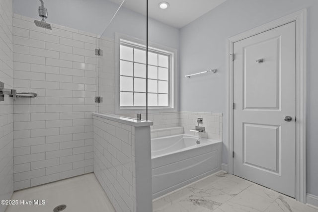 full bathroom with a bath, marble finish floor, and a tile shower