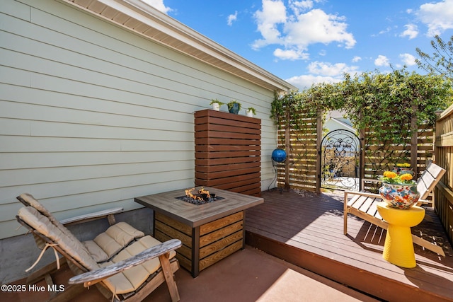 wooden terrace with an outdoor fire pit