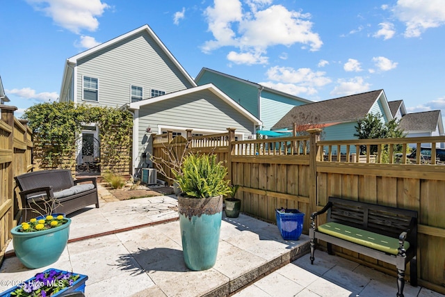 view of patio / terrace featuring cooling unit and fence private yard