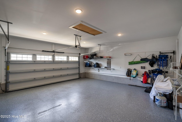 garage with a garage door opener and recessed lighting