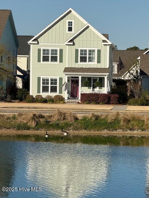 view of front facade featuring board and batten siding and a water view