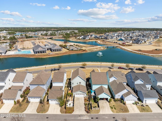 drone / aerial view with a residential view and a water view