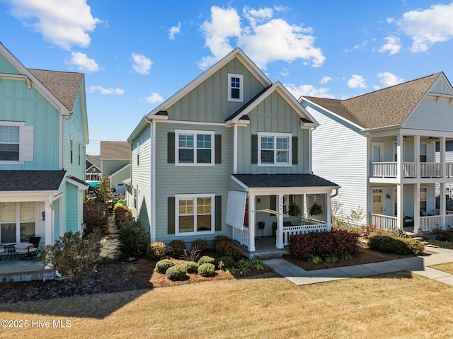 view of front of property featuring a porch, a front yard, and board and batten siding