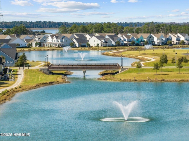 birds eye view of property with a residential view and a water view